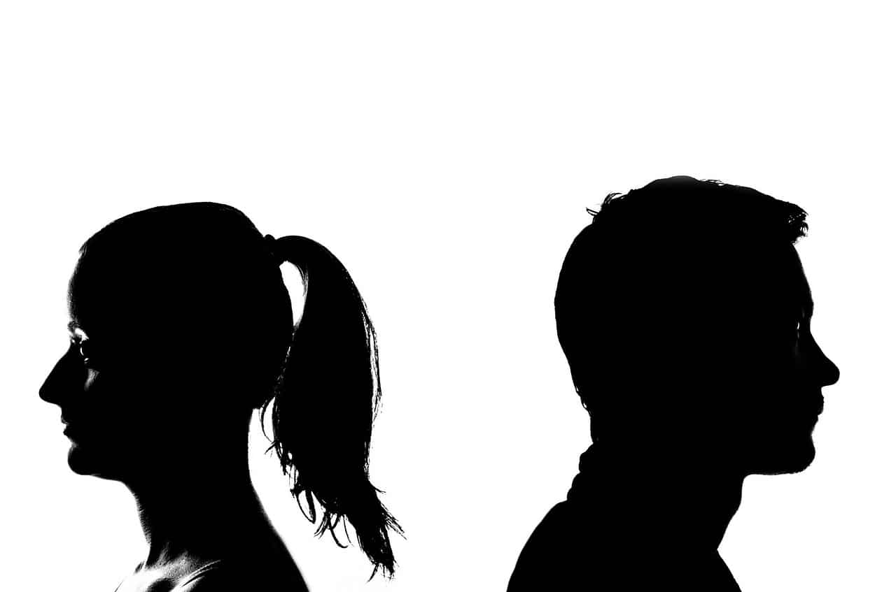 A couple in silhouette facing away from each other, representing an acrimonious separation