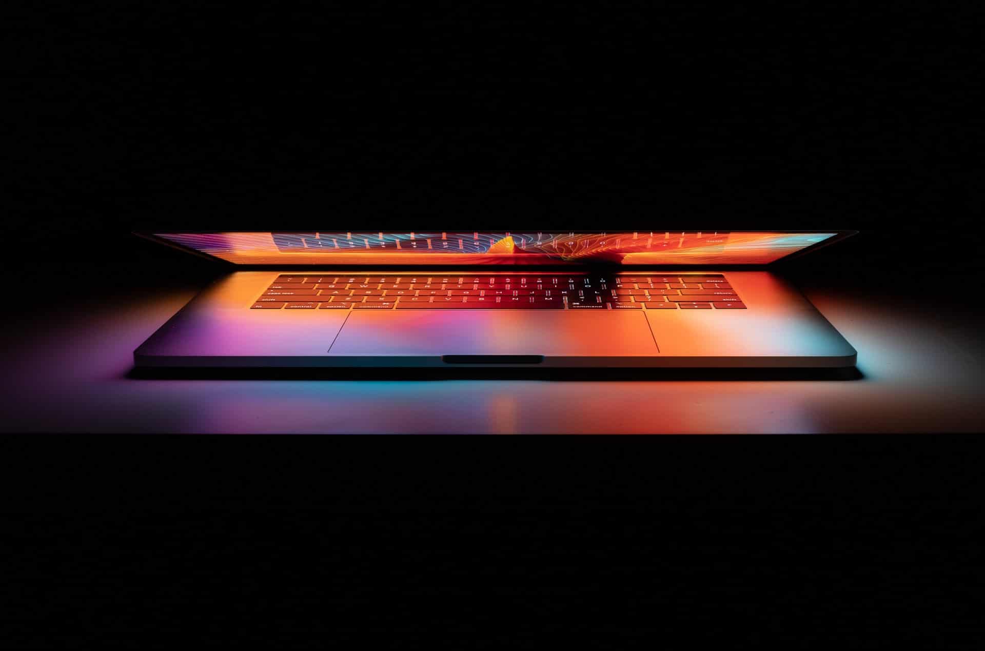 A laptop partially closed, but radiating light from the screen representing digital tools to make divorce easier