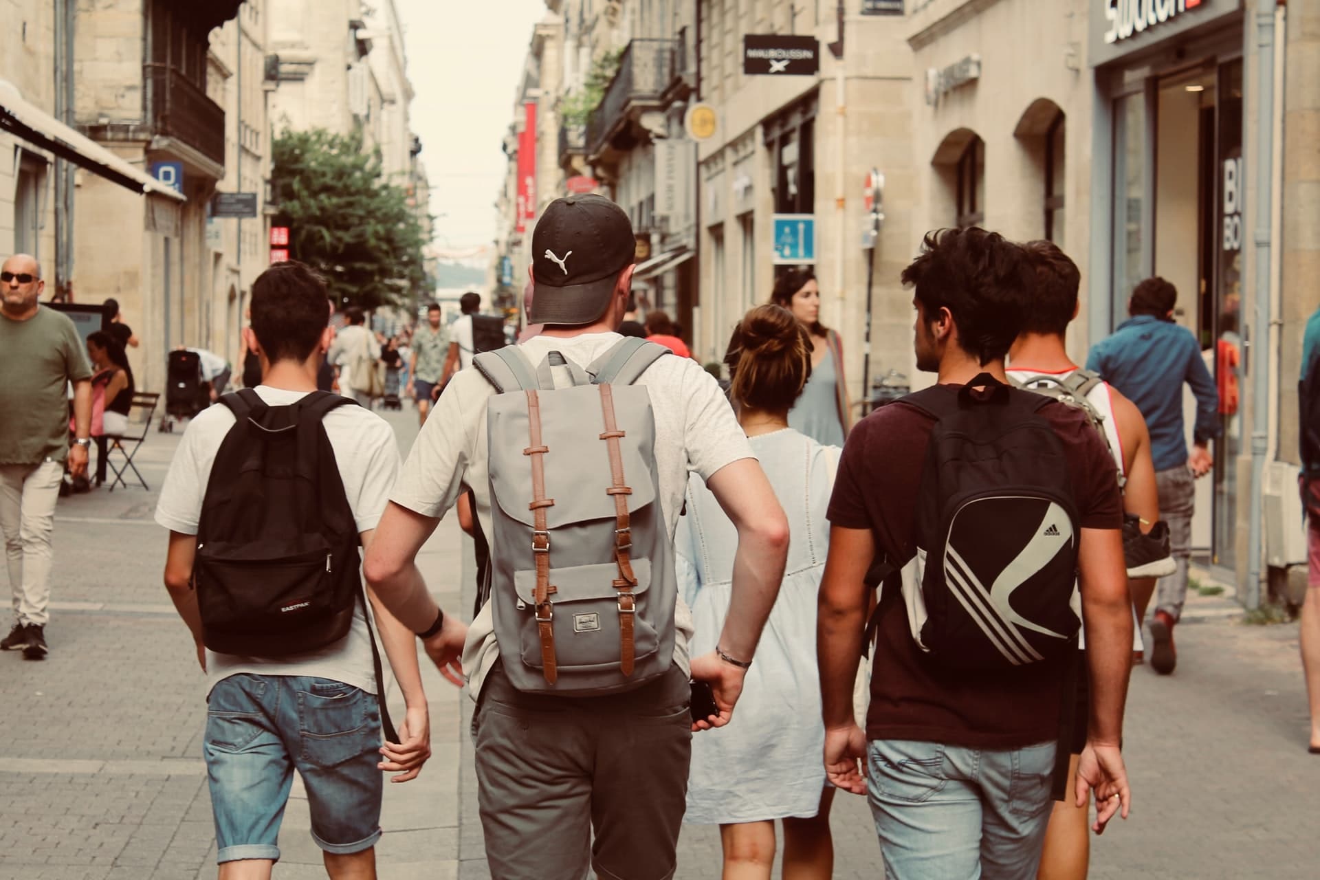 A teenage boy walking with friends representing a child who successfully sought estrangement from an abusive mother