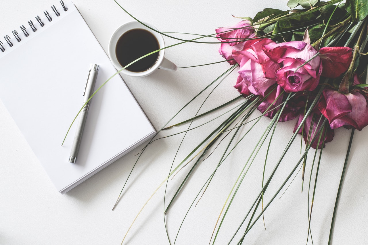 Roses next to a notebook representing a foreign wedding contract
