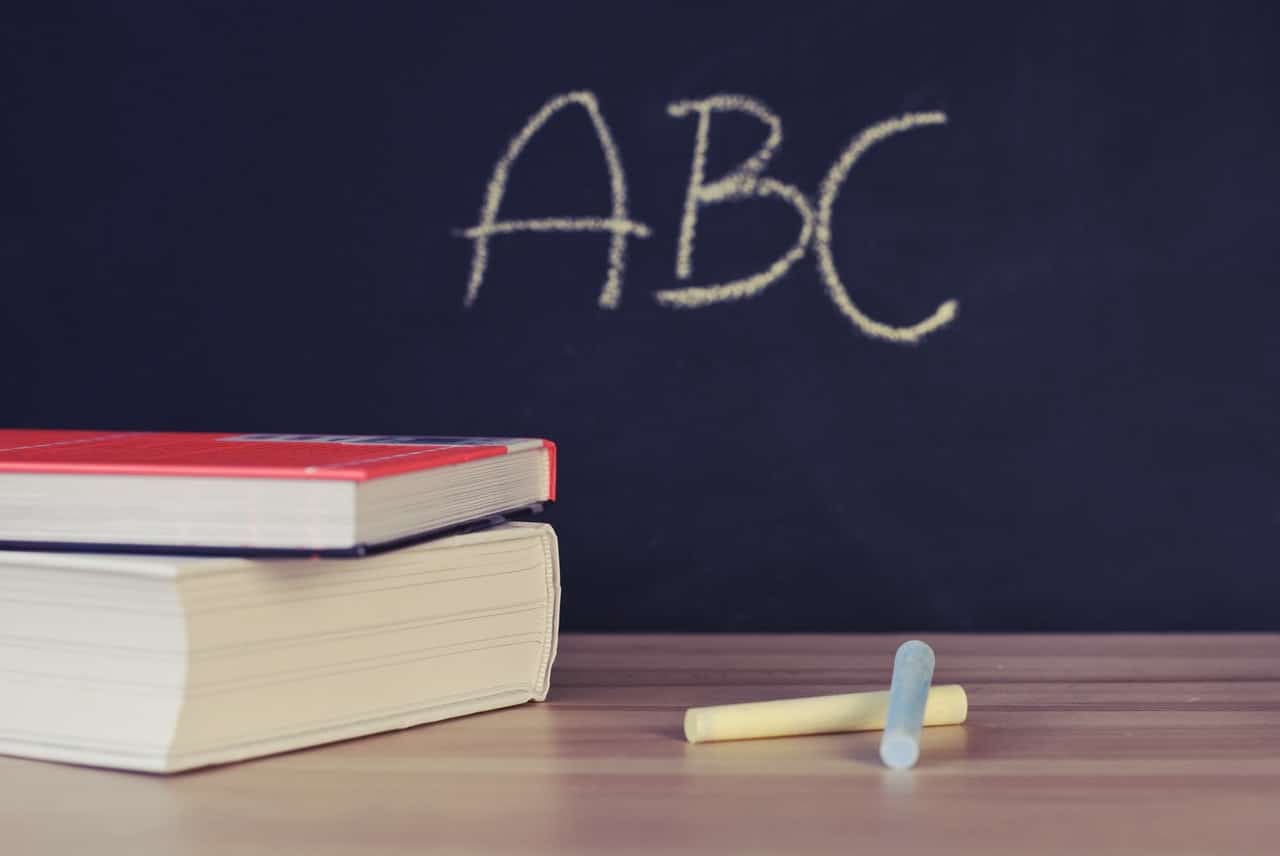Books and a chalkboard reading ABC, representing potential scenarios for school reopenings in Alberta
