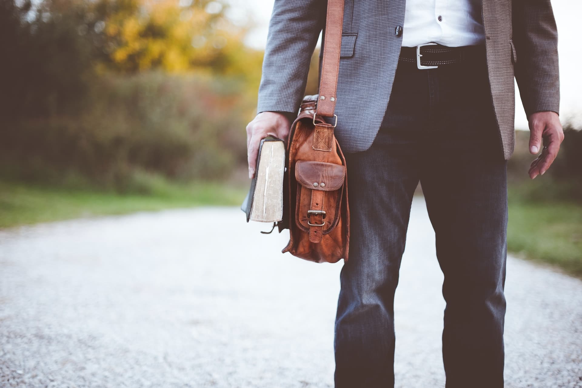 A man with a briefcase and a large book representing a person who is representing themselves in court