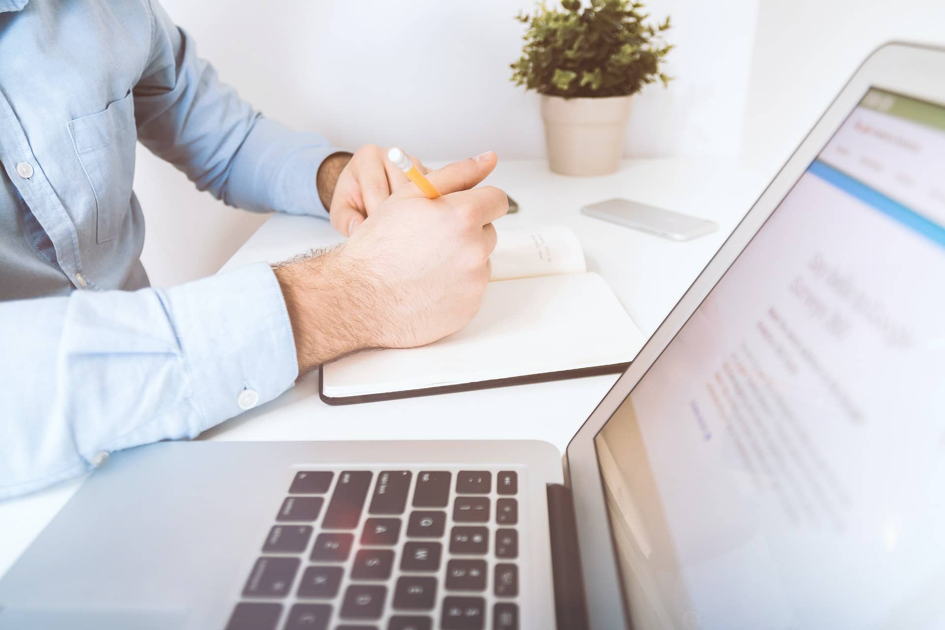 A man with a laptop and notebook representing a psychologist providing a parenting assessment