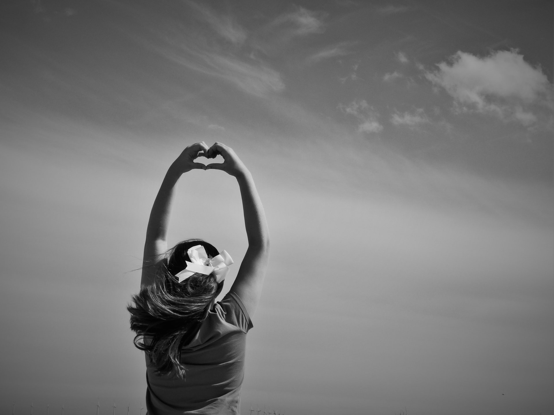 A girl making a heart wiht her hands representing child marriage in canada