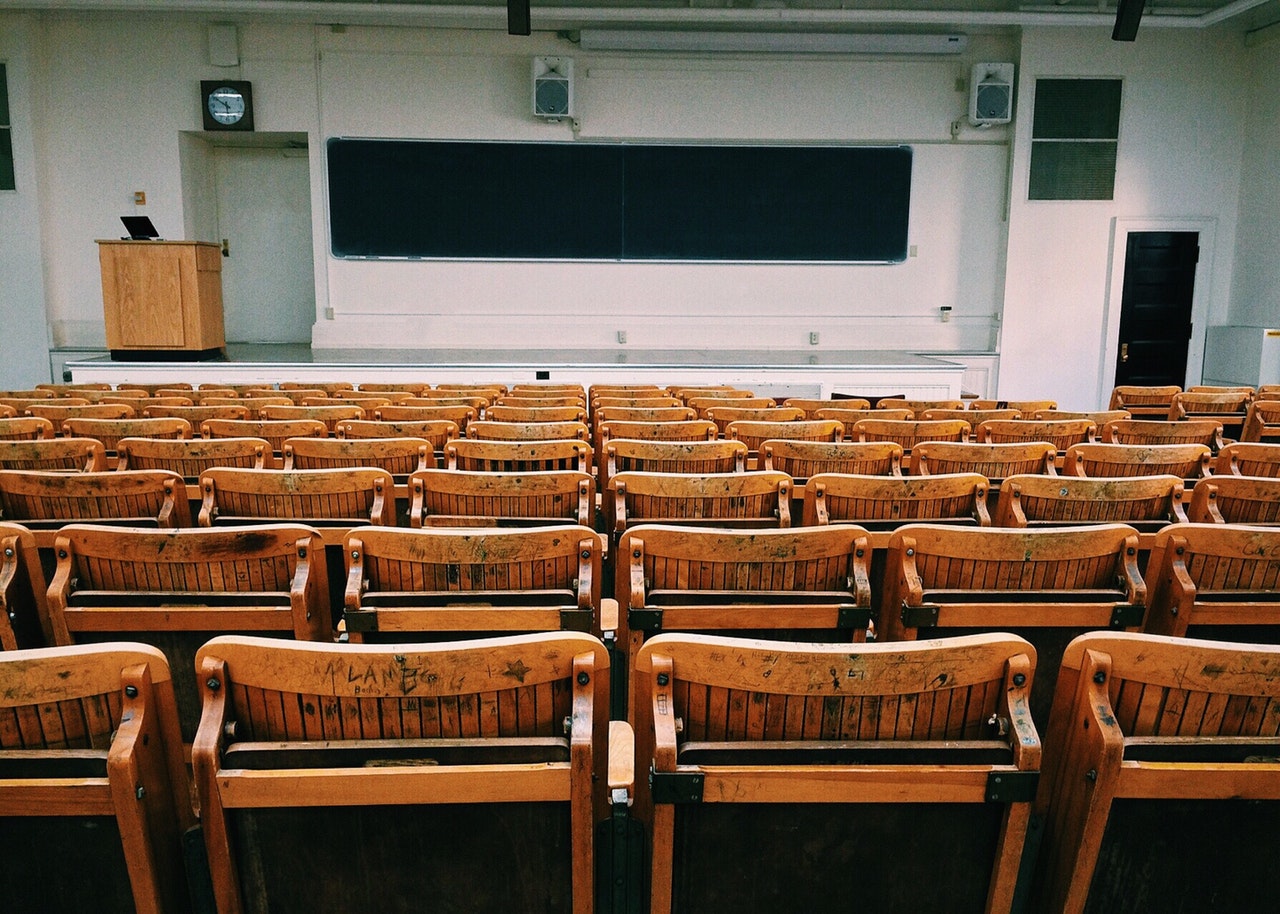 A college lecture hall representing child support put on hold while children postpone post-secondary education