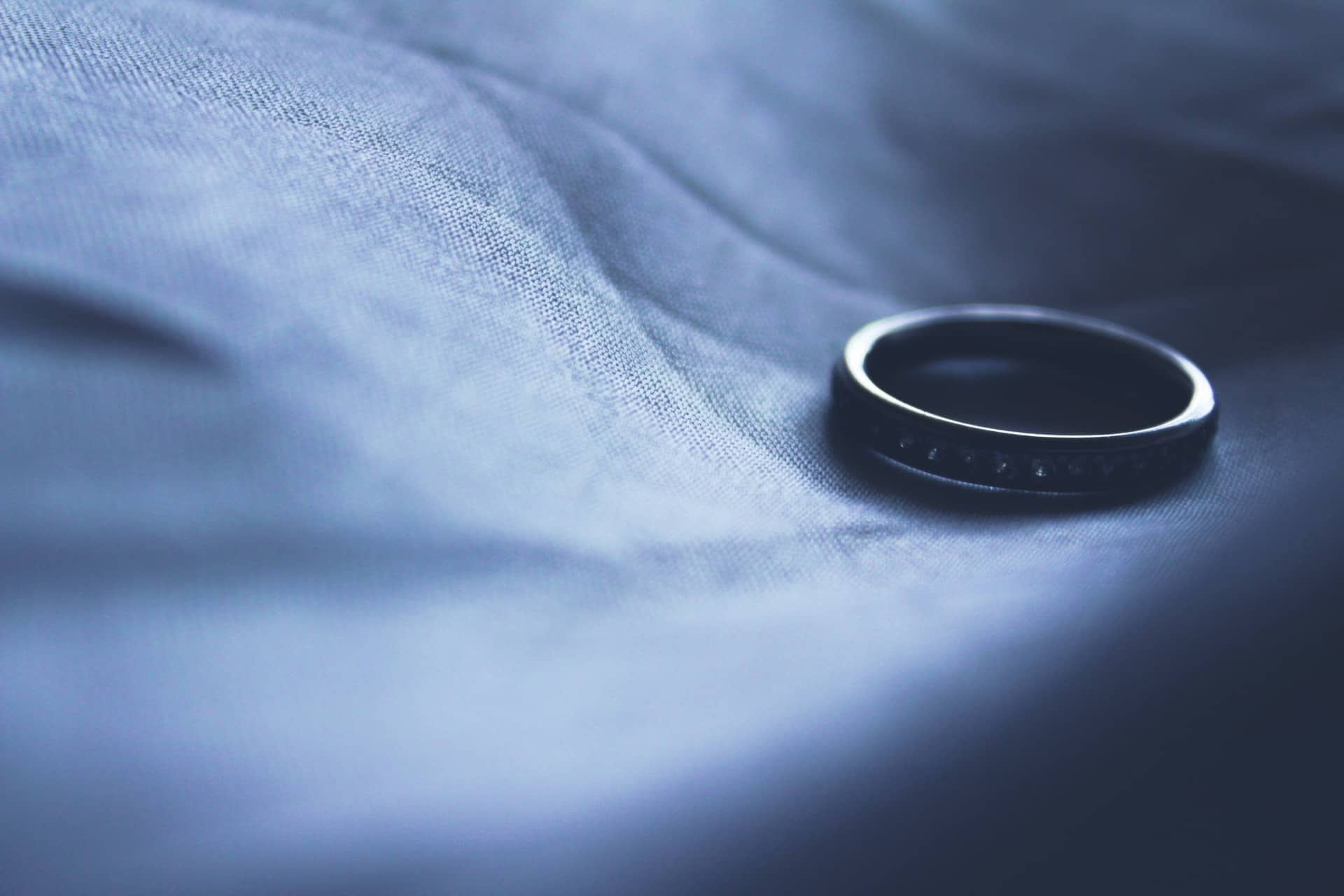 A sole wedding ring in shadow representing a man who hired a paralegal to file his divorce and got scammed
