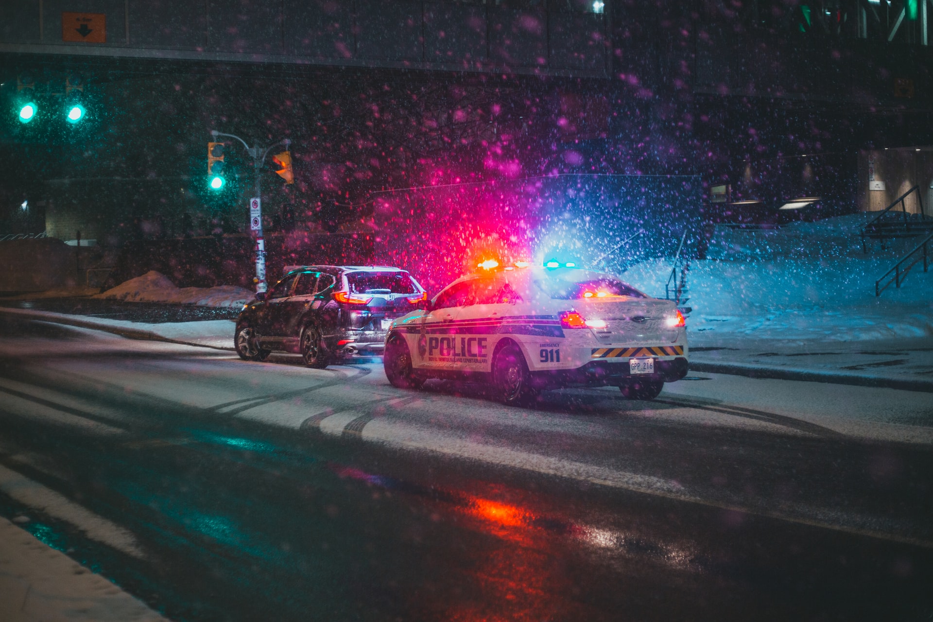A police car with lights flashing representing tactics used by a police officer involved in a bitter divorce proceeding with his former wife