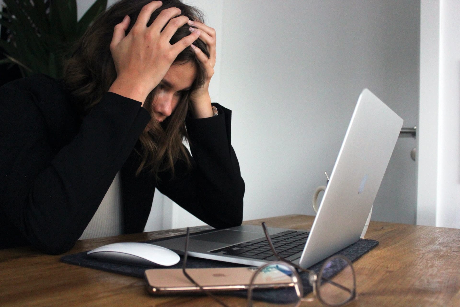 A woman upset looking at a laptop representing revenge porn