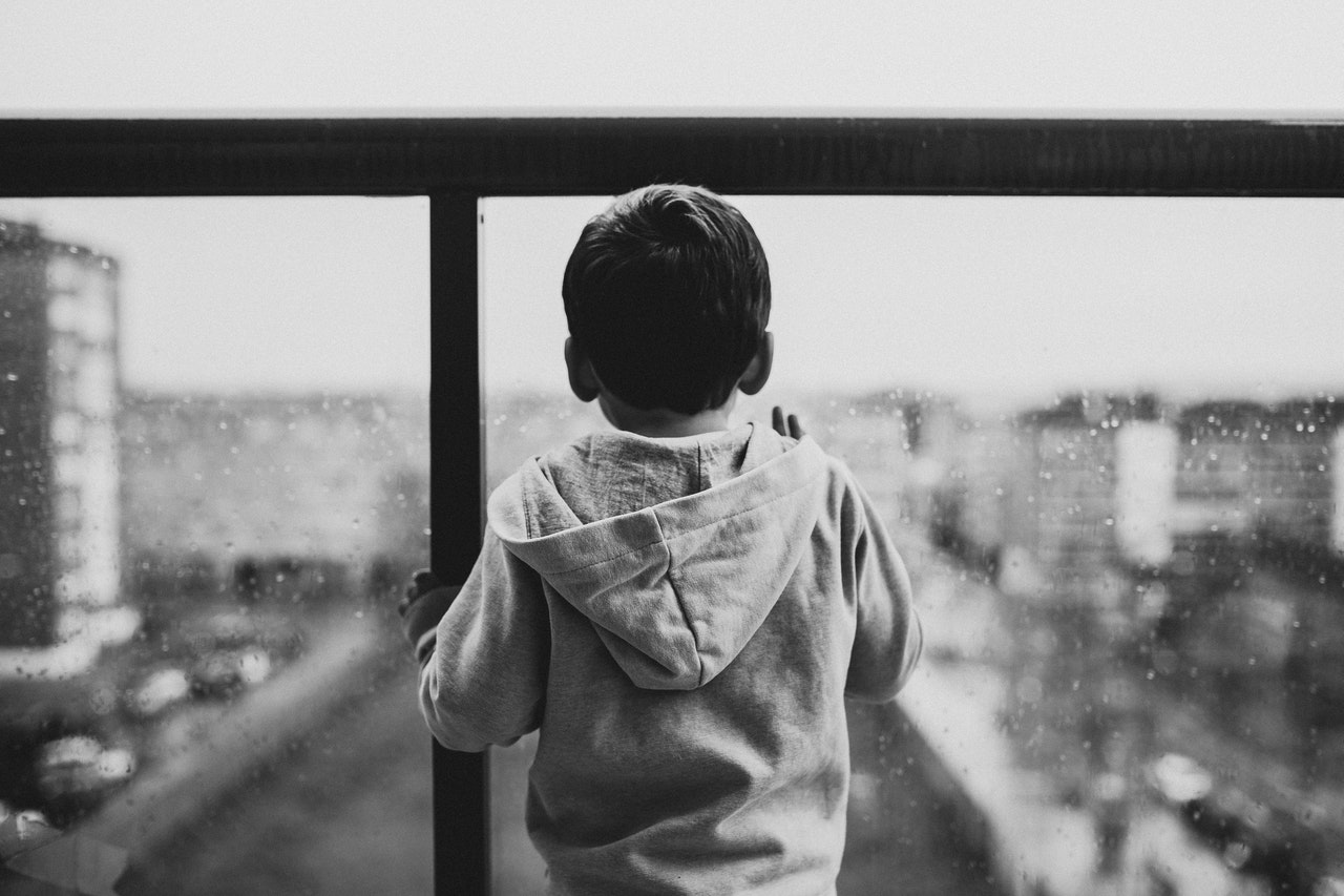 Child looking our a window