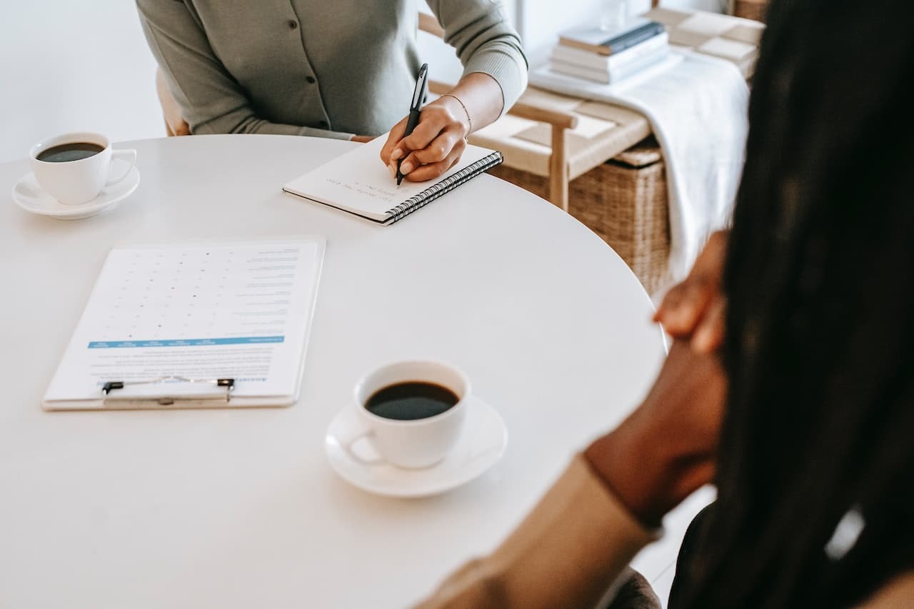 interviewer writing in notepad