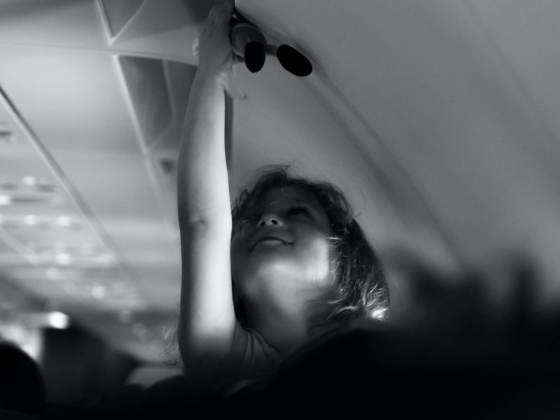 toddler holding toy in airplane