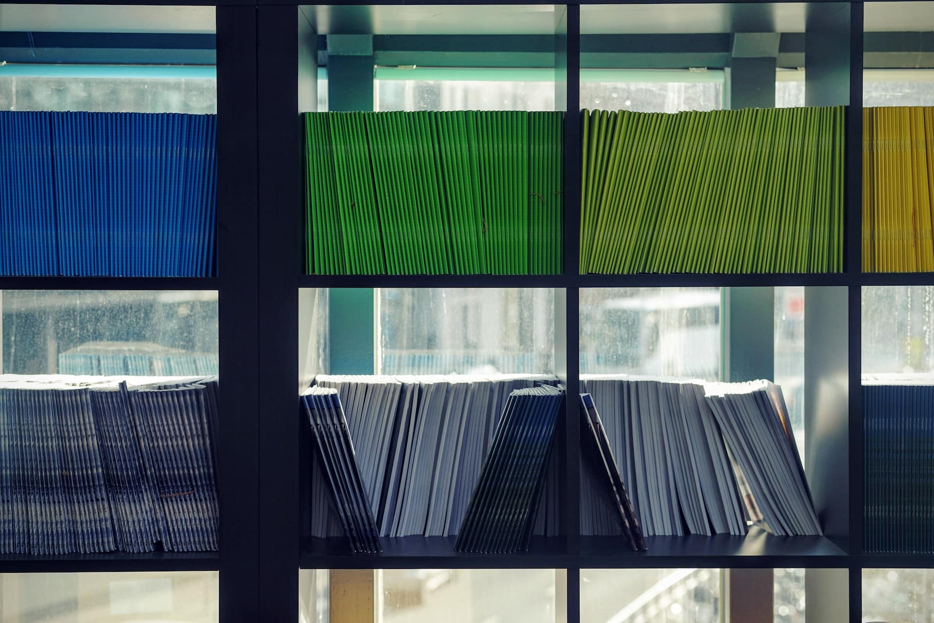assorted colour file folders on a shelf