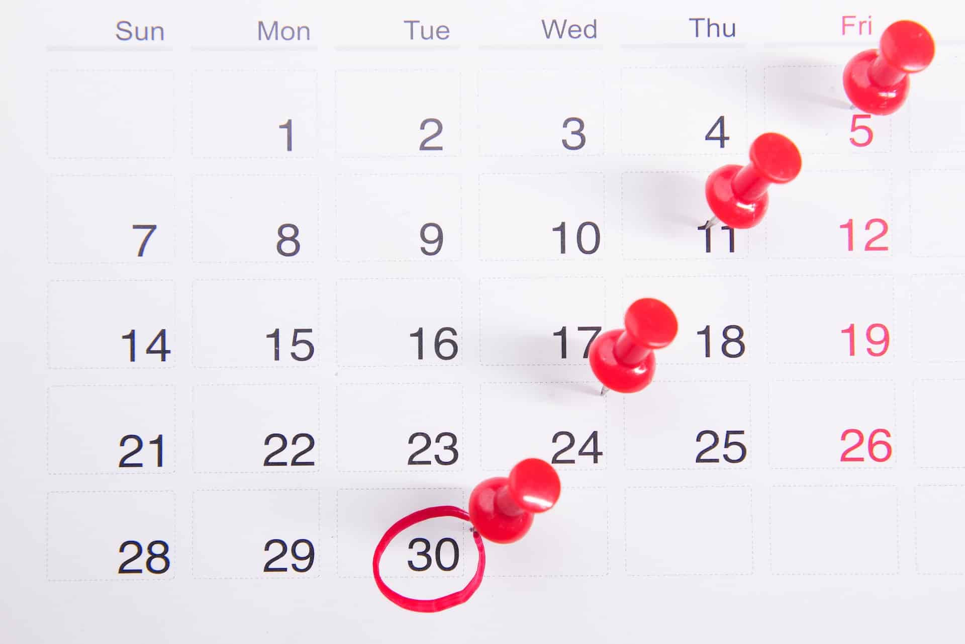 a calendar with red push buttons