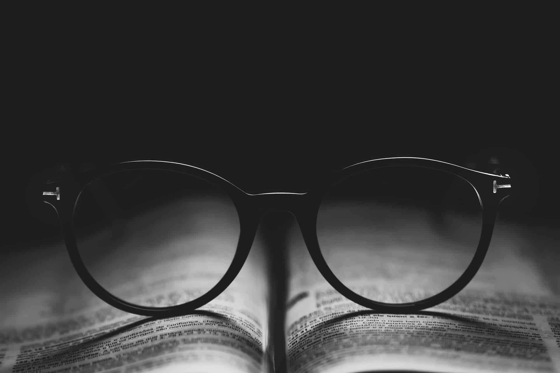 photo of glasses sitting on an open book