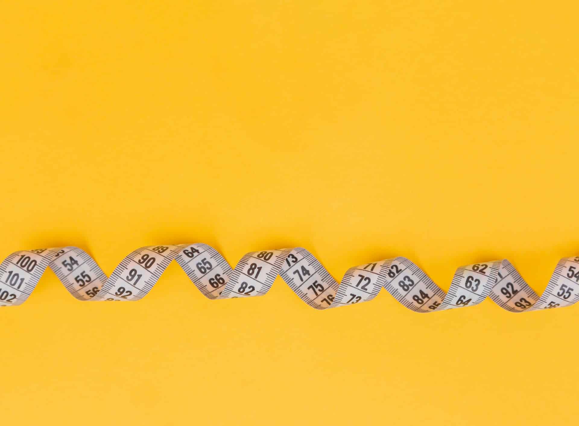 measuring tape on yellow background