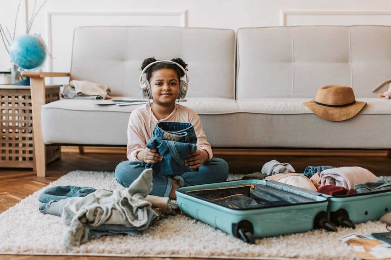 a child sitting with suitcase